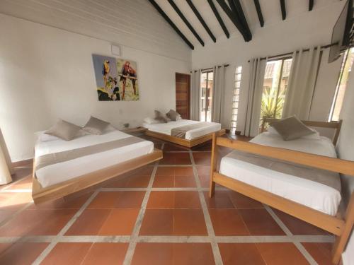a room with two beds in a room at La Manola Finca Hotel in Doradal