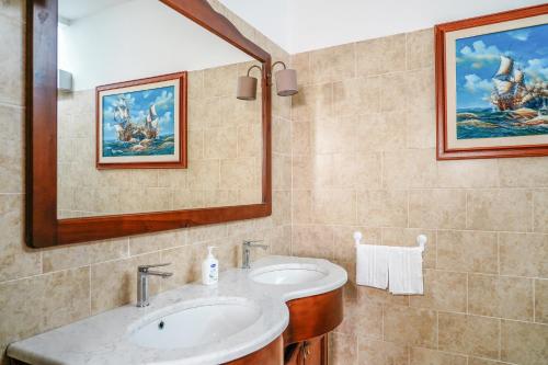 a bathroom with a sink and a mirror at Appartamento Marirò in Racale