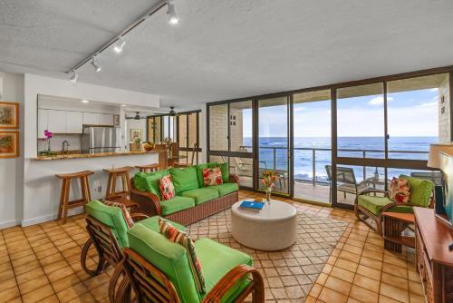 a living room with a view of the ocean at Kuhio Shores 215 in Koloa