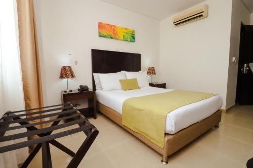 מיטה או מיטות בחדר ב-Hotel Millenium Barrancabermeja