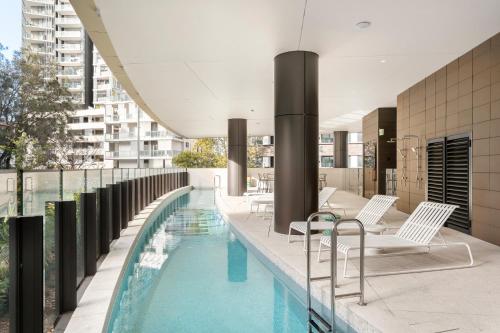 a swimming pool on the roof of a building at Urban Rest Parramatta Apartments in Sydney