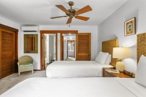 a bedroom with two beds and a ceiling fan at Nihi Kai 509 Close to Beaches in Koloa