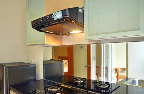 a kitchen with a stove top oven in a kitchen at Oxy House Bali in Sanur