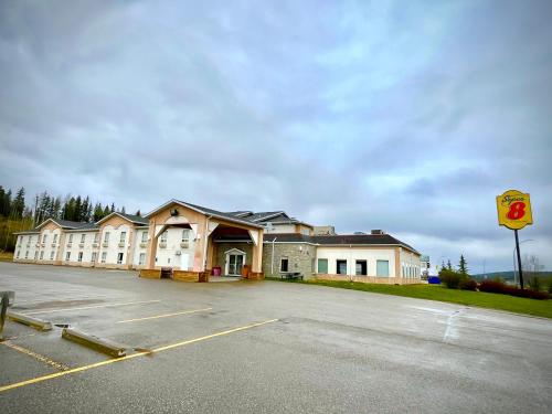 an empty parking lot in front of a building at Super 8 by Wyndham Hinton in Hinton
