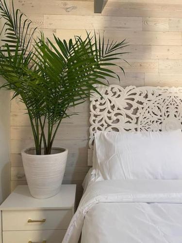 a plant sitting on a night stand next to a bed at 10 guest Ski Chalet Pools Golf Ski Hike in Vernon Township