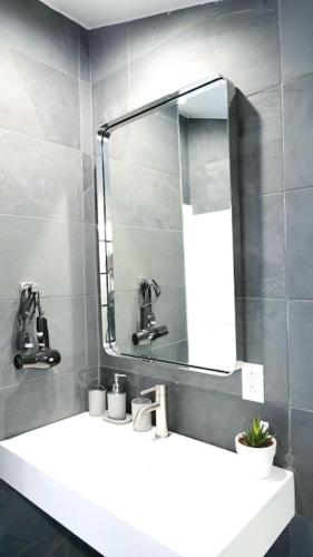 a bathroom with a white sink and a mirror at 10 guest Ski Chalet Pools Golf Ski Hike in Vernon Township