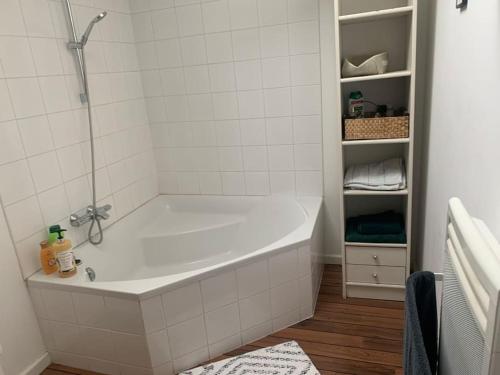 a white bath tub in a white bathroom at Appartement DuplexCœur de Ville in Metz