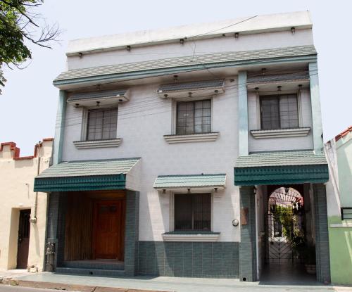 a white building with windows on a street at Privada Guadalupe in Monterrey