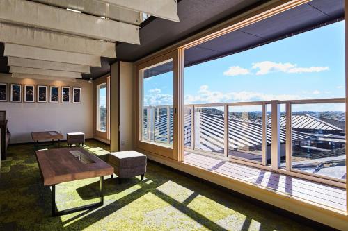 a room with a large window with a table and a view at Villa Ryusei in Ugata