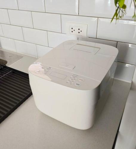 a white toilet sitting on a counter in a kitchen at Kiddie Hostel Unit30A-kids and pets friendly in Subic bay freeport zone in Kababae