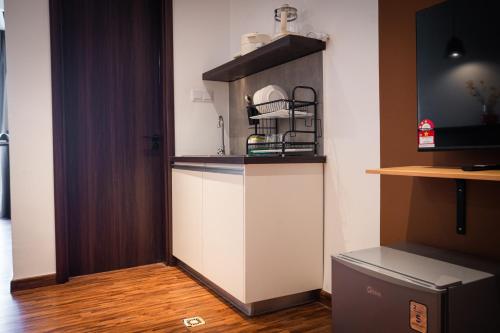 a kitchen with a counter with a shelf at K Avenue by Pinstay in Donggongon