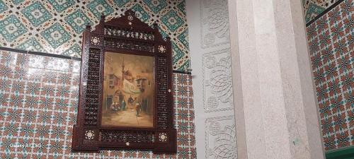 a picture of a painting on a wall at Dar Tayeb in Tunis