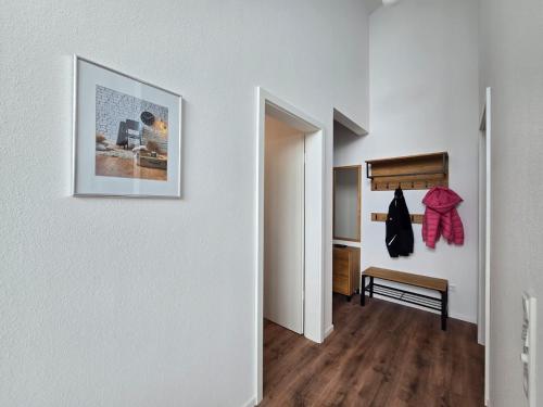 a hallway with white walls and a picture on the wall at Ferienwohnung Emil in Norden
