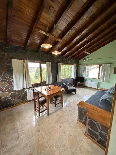 a living room with a table and a couch at KaiKen Lauquen in Trevelin
