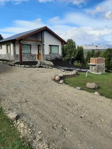 a house on the side of a gravel road at KaiKen Lauquen in Trevelin