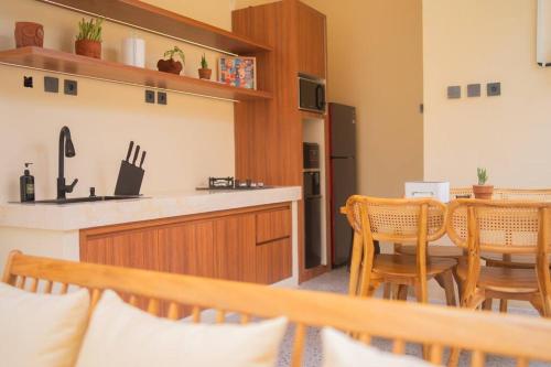 a kitchen with a table and chairs in a room at Villa Benih Uluwatu in Jimbaran