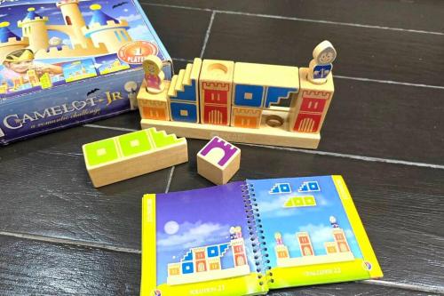 two toy trains and a book on a table at Kiddie Hostel Unit 30B-kids and pets friendly in Subic bay freeport zone in Kababae