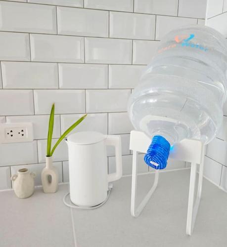a bottle of water sitting on a white chair at Kiddie Hostel Unit 30B-kids and pets friendly in Subic bay freeport zone in Kababae
