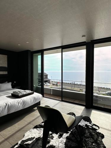 a bedroom with a bed and a view of the beach at private villa クニウミ之チ in Awaji