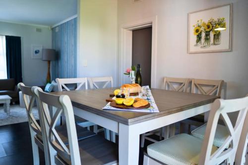 a dining room table with a plate of food on it at Grantley Retreat 8 Grantley Ave Victor Harbor - No Linen Included in Victor Harbor