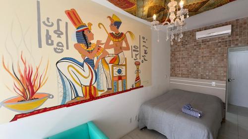 a bedroom with a painting on the wall at Hotel das Palmas in Florianópolis