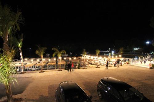 two cars parked in a parking lot at night at Melina's Seaside Retreat in Ksamil