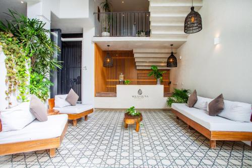 a living room with white couches and plants at Agua de Luna Boutique Hotel in San Francisco