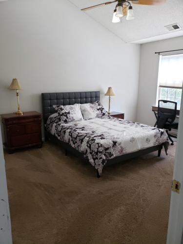 a bedroom with a bed and a chair and a window at Gathering Place in Charlotte