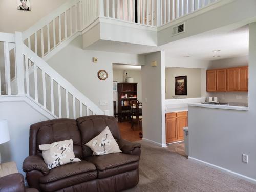 a living room with a couch and a staircase at Gathering Place in Charlotte