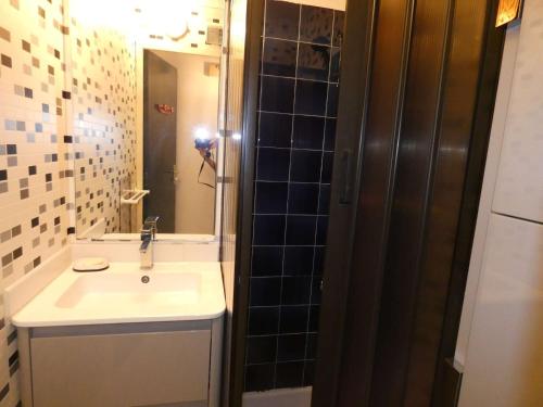 une salle de bain avec un lavabo et un miroir dans l'établissement Bel appartement 2 pièces avec loggia vitrée, au calme, proche plage et commerces, parking inclus - FR-1-328-237, à La Grande Motte