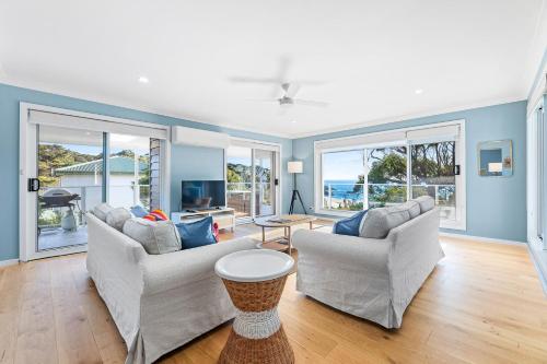 a living room with two couches and a television at 198 Mystery Bay Road, Mystery Bay in Mystery Bay