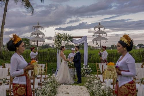a bride and groom at their wedding ceremony at Gdas Bali Health and Wellness Resort - Adult Only in Ubud