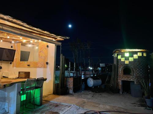 a house with a fireplace in a yard at night at Casa palmera in San Baltasar