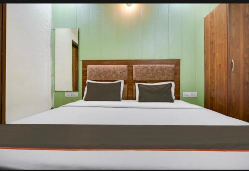 a bedroom with a large bed with two pillows at Hotel deep bell hotel in Chandīgarh
