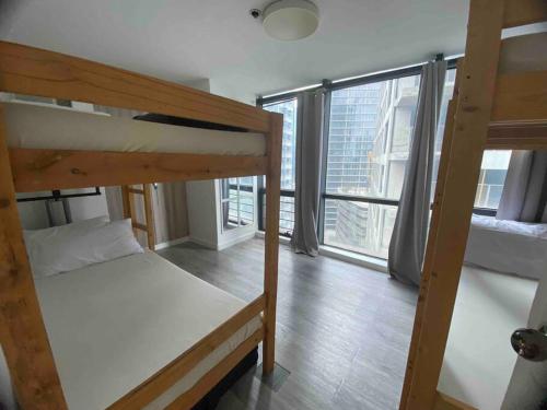 a room with two bunk beds and a large window at 41sqm 1BR in Center of Ortigas Center in Manila