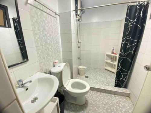 a bathroom with a sink and a toilet and a shower at 41sqm 1BR in Center of Ortigas Center in Manila