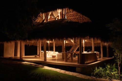 a night view of a house with a patio at SumbaFarmHouse in Patiala Bawa