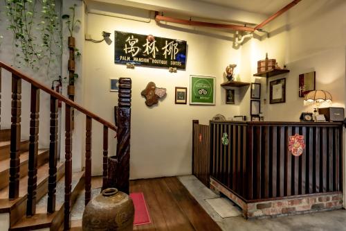a room with a staircase and a sign on the wall at Palm Mansion Boutique Suites in George Town