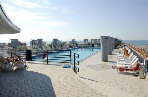 a swimming pool on the top of a building at Charming flat with shared pool - Beahost in Bibione