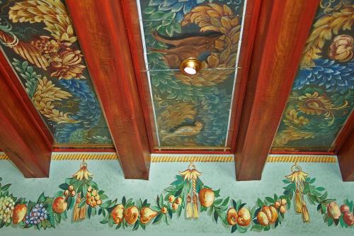 a ceiling with a painting of fruits and vegetables at Hotel Spa et Restaurant Au Chasseur in Birkenwald