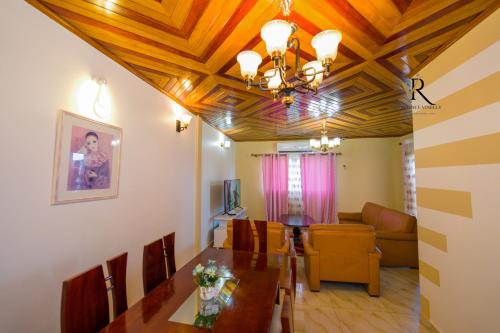 a living room with a table and a dining room at Résidence Vinelly in Douala
