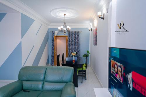 a living room with a couch and a dining room at Résidence Vinelly in Douala