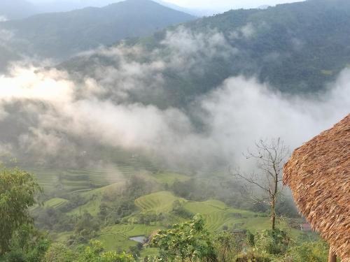 a view of a mountain with clouds and trees at Hoàng Su Phì - Móng Ngựa Homestay in Ha Giang