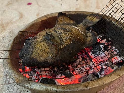 a dead fish is cooking on a grill at Hoa Bien Motel in Ly Son