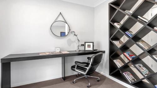 a desk with a mirror and a chair in a room at The Residence in Pokolbin