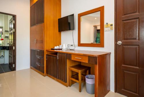 a bathroom with a vanity with a mirror and a sink at Phatcharee Resort in Baan Tai