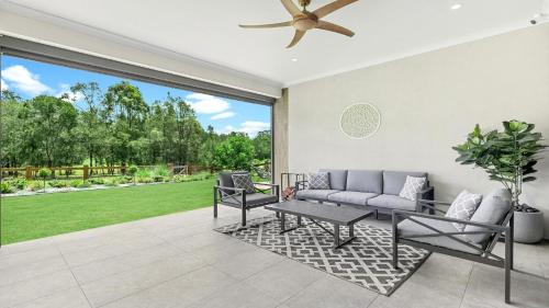 a living room with a couch and a table at Willow's Green in Pokolbin