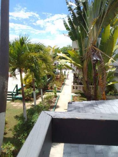a view of a park with palm trees and a bench at Studio Apt on 7 Mile Beach at Negril Beach Club in Negril