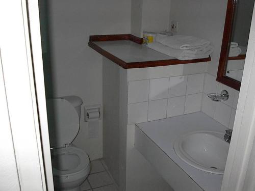 a small bathroom with a toilet and a sink at Studio Apt on 7 Mile Beach at Negril Beach Club in Negril