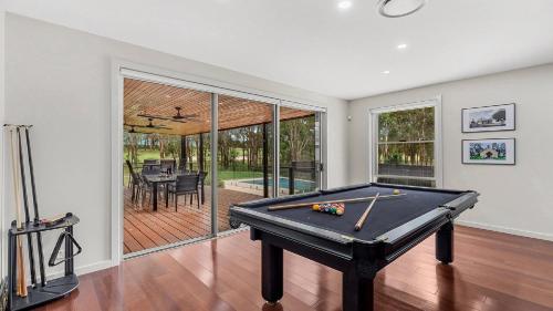 a pool table in a living room with a pool table at The Clubhouse Pokolbin in Pokolbin